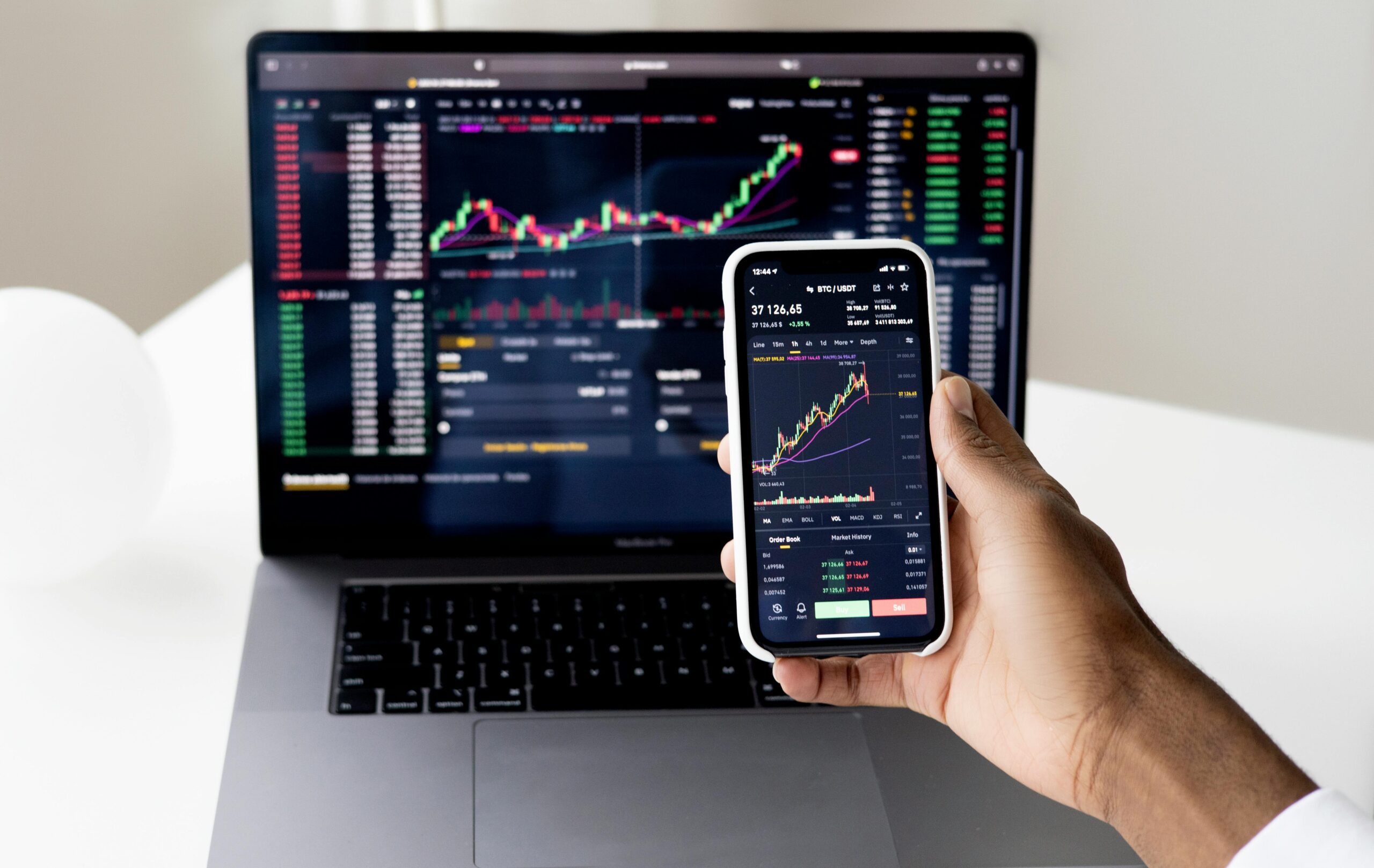 hand holding phone in front of chart